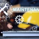 A close-up of a worker's hand pointing to a graphic that reads "Maintenance" with a screwdriver and wrench.